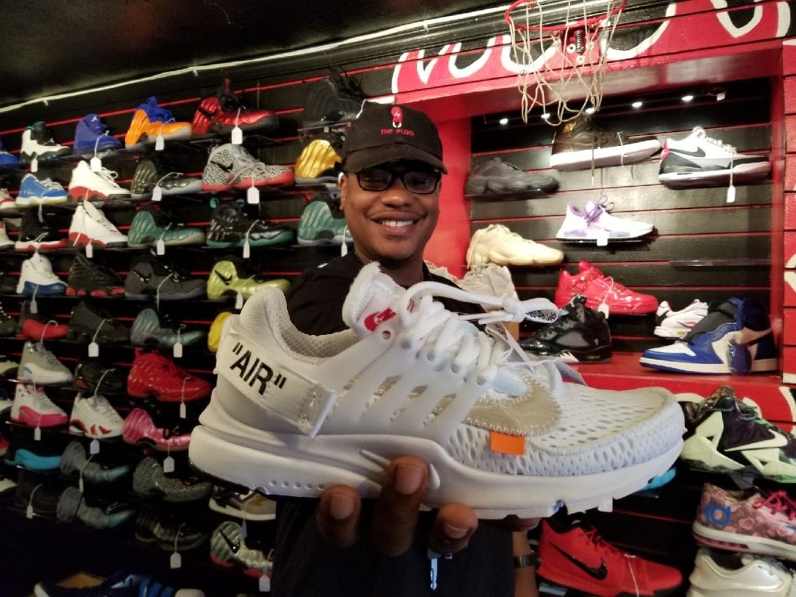 Owner of the Plug holding up Off-White Nike Air Presto